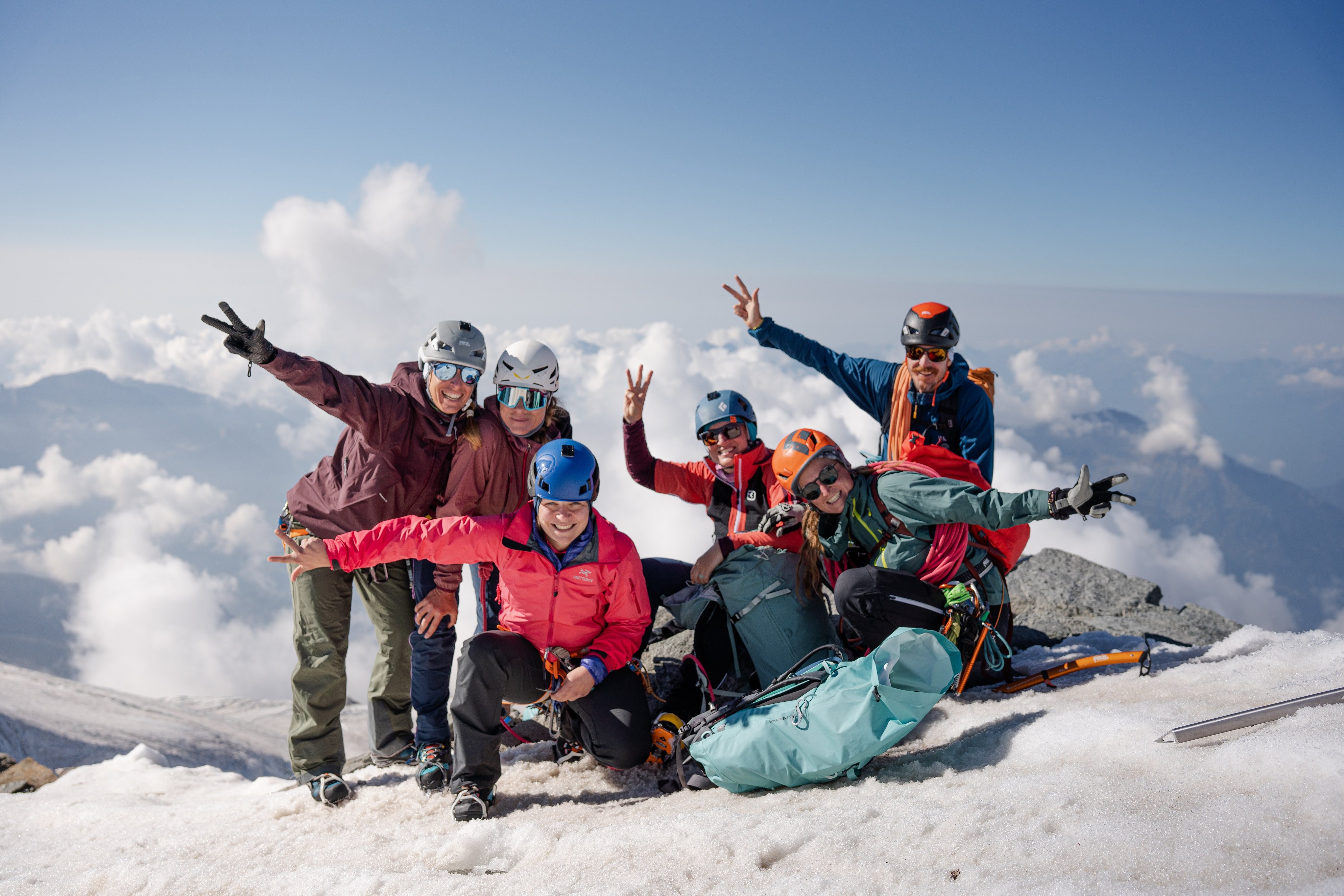 6 people on top of Castor showing 3 fingers each to say it's their third peak