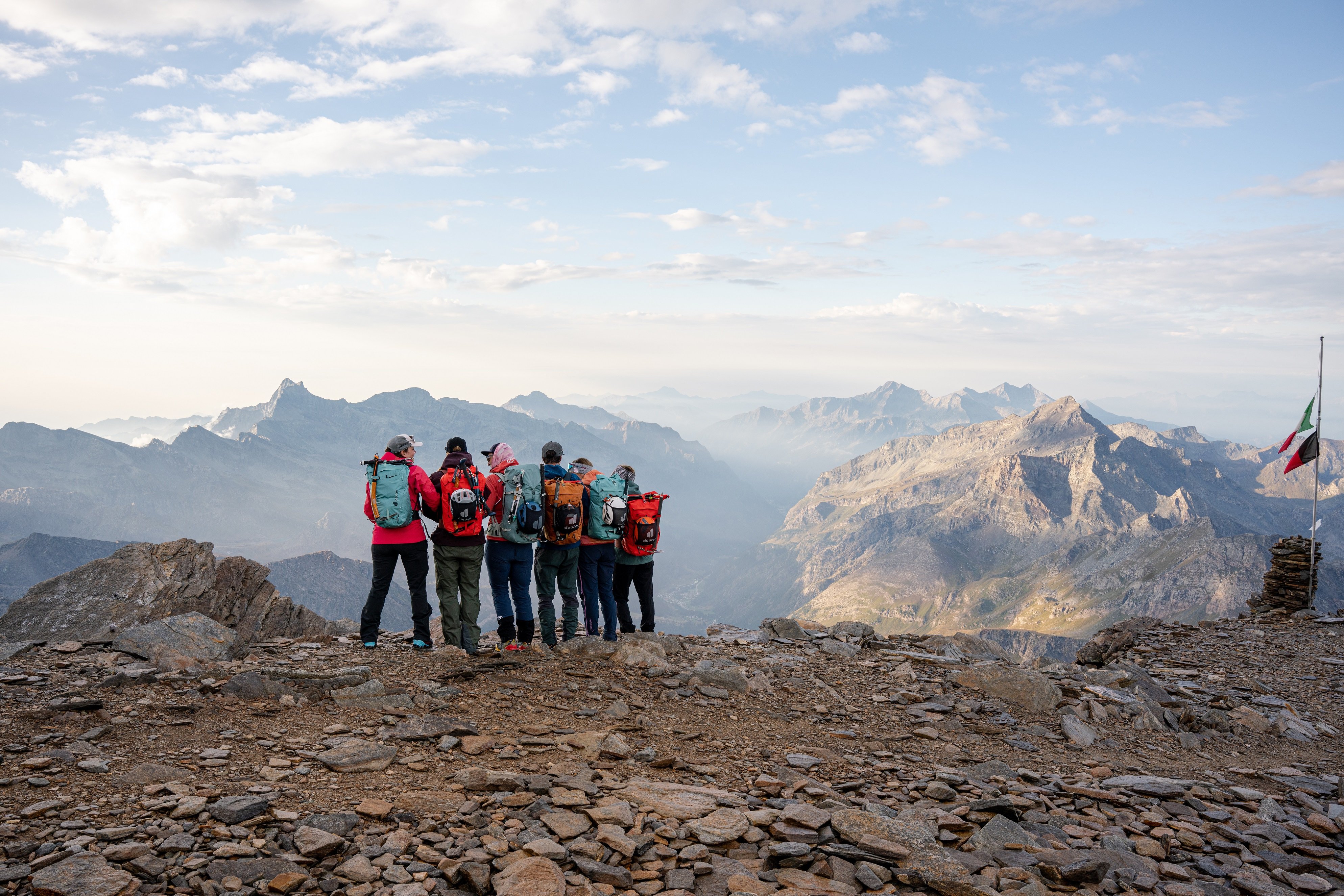 6 hikers look out at the mountain scenery 