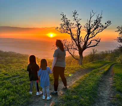 Amy and her daughters view the sunset